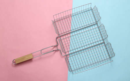 Steel grid for grill on pink blue background