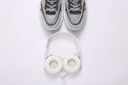 Sports shoes and headphones on white background. fitness concept. top view. minimalismの写真素材