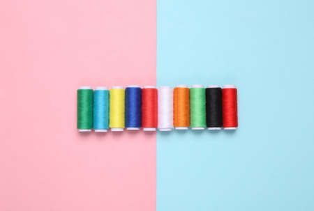 Skeins of colored thread on a blue-pink pastel background