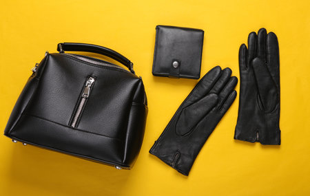 Leather bag, wallet and gloves on yellow background. top viewの写真素材