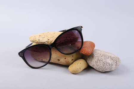 Sunglasses with stones on a gray background. minimalism beauty conceptの写真素材