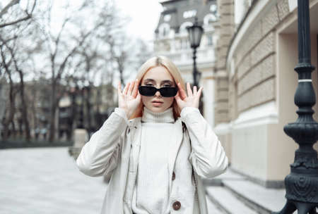Portrait of fashion woman in trendy stylish sunglasses in the cityの写真素材
