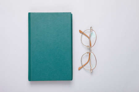 Book and optical eyeglasses on gray backgroundの写真素材