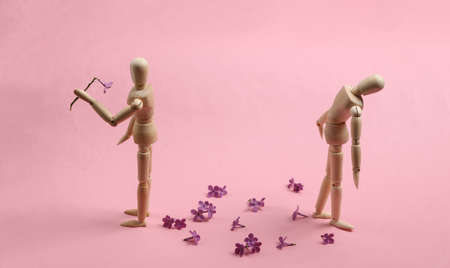 broken heart. Two puppets on a pink background. Parting, attitudeの写真素材