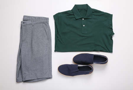 Shorts, summer shoes and T-shirt with collar on white background. top view. flat layの写真素材