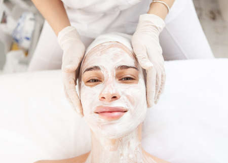 skincare. Beautiful woman in rejuvenating mask in beauty salonの写真素材