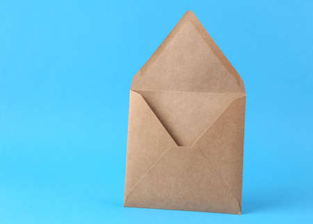 Open blank craft envelope on blue background