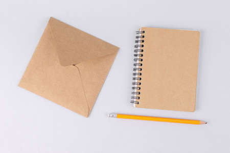 Craft notebook and envelope on white backgroundの写真素材