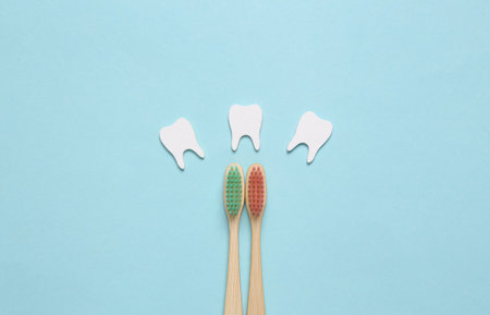Dental care concept. Eco toothbrushes with teeth on blue background. top view. flat layの写真素材