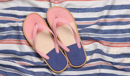 Flip flops on a striped surface. beach vacation concept