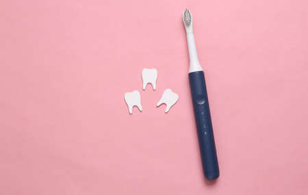 Dental care concept. Toothbrush with teeth on pink background. top view. flat layの写真素材