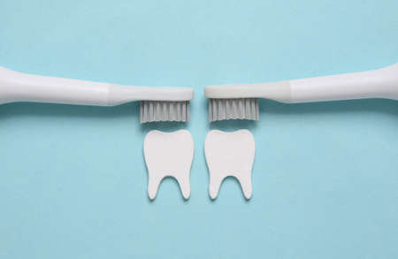 Dental care concept. Toothbrushes brush teeth on blue background. top view. flat layの写真素材