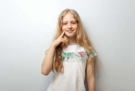 Little funny blonde girl on white backgroundの写真素材