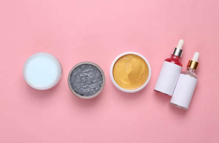 Set for facial care on a pink background. Flat lay beauty composition. Skin care, lifting face concept. top viewの写真素材