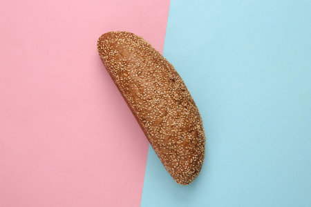 Loaf of cereal bread on a blue pink background
