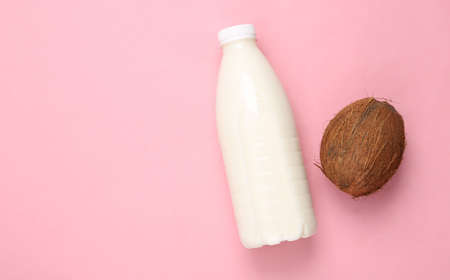 Milk bottle with coconut on pink backgroundの写真素材