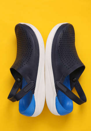 Men's beach sandals on yellow background. top view