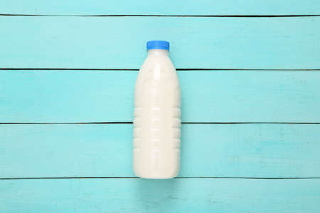 Milk bottle on blue wooden table. top viewの写真素材