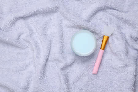Face cream jar on a towel. top viewの写真素材