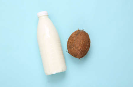 Milk bottle with coconut on a blue backgroundの写真素材
