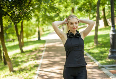 Portrait of young fitness woman in the park