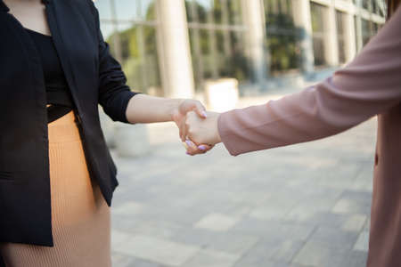 Handshake of two business women outdoors. partnershipの写真素材