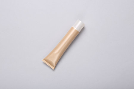 Tube of foundation on gray background. top viewの写真素材