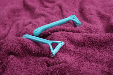 Shaver epilators on a towel close-up. Personal care, hygieneの写真素材