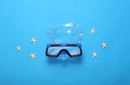 Diving mask with starfish on a blue background