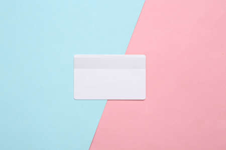White bank card on blue pink pastel background