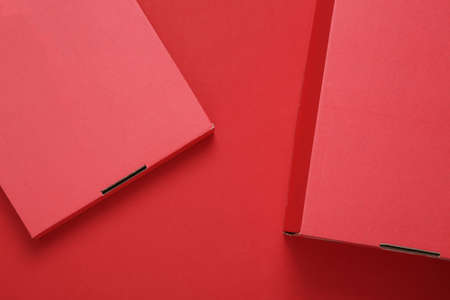 Red cardboard box on a red background. Mock up