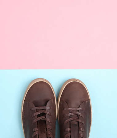 Mens brown leather sneakers on pink blue background. top viewの写真素材
