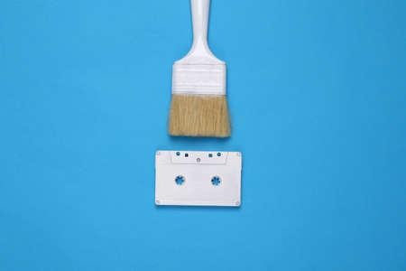Paintbrush with audio cassette on blue background. creative layoutの写真素材