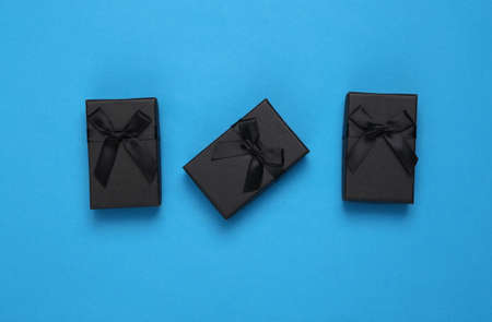 Black gift boxes on blue background. top viewの写真素材