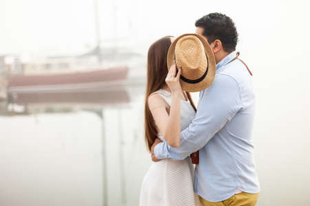 Loving couple kissing closed by hatの写真素材