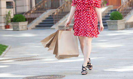 Woman holding shopping packages in the cityの写真素材