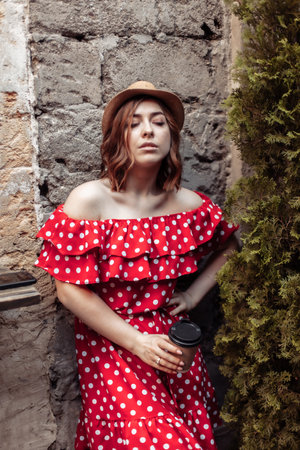 Dramatic portrait of a woman in a red polka dot dressの写真素材