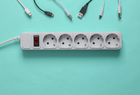 Different usb cables and Electrical Extension cord on a blue background.の写真素材