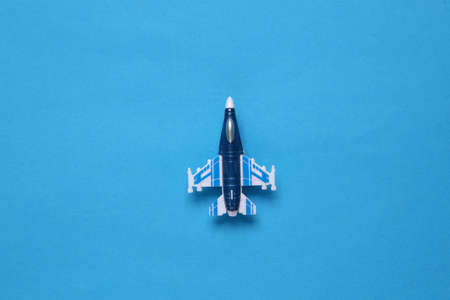 toy fighter plane on blue backgroundの写真素材