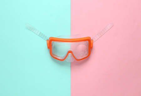 Diving mask on pink blue background. top viewの写真素材
