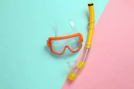 Diving mask with snorkel on pink blue background. top viewの写真素材