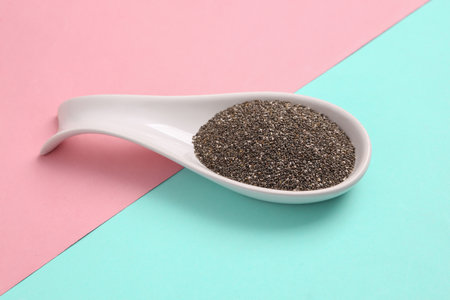 Ceramic spoon with chia on a blue pink background. top viewの写真素材