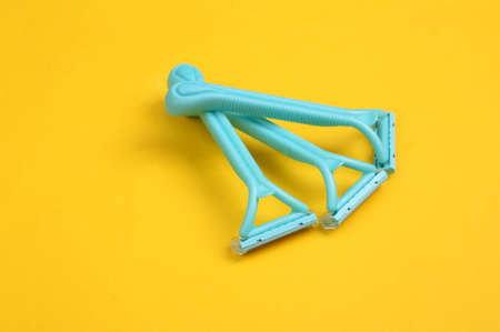 Set of disposable razors for depilation on yellow background.の写真素材