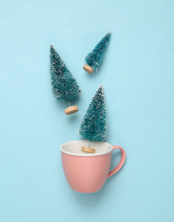 Tea cup with Christmas trees on a blue backgroundの写真素材