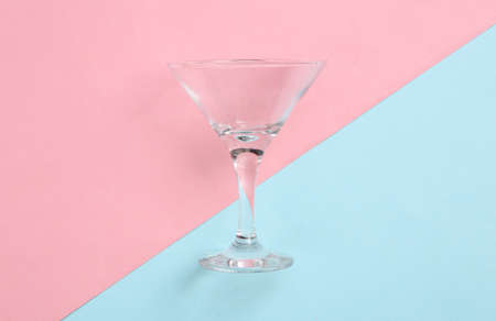 Cocktail empty glass on a blue-pink pastel background. minimalism. top viewの写真素材