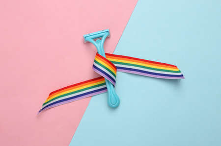 Shaver depilator with rainbow lgbt tape on blue pink pastel backgroundの写真素材