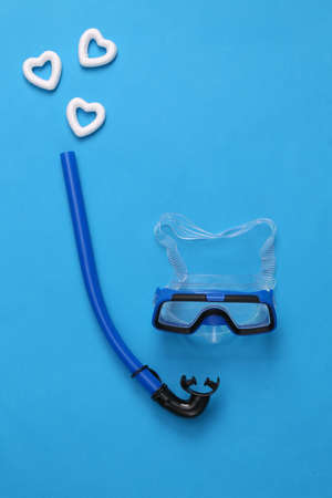 Diving mask with snorkel and hearts on a blue background. love, travel conceptの写真素材