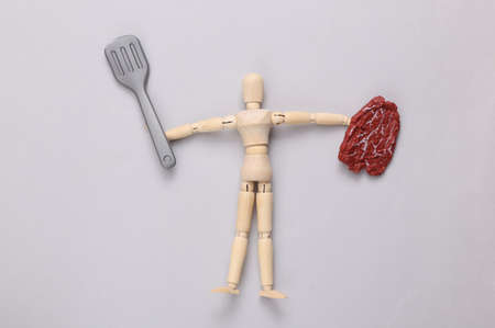 Wooden puppet chef on gray backgroundの写真素材