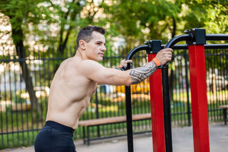 Muscular athletic man with a naked torso on the workout groundの写真素材