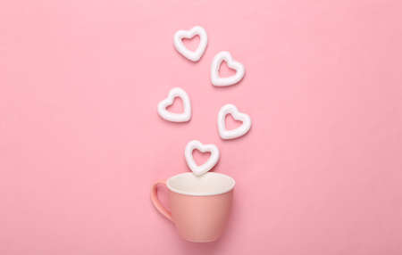 Cup with white hearts on a pink background. creative layout. Love concept, happy valentines day
